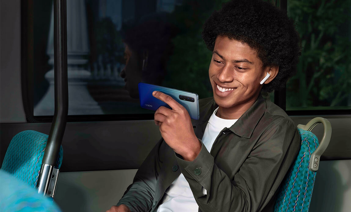Osoba trzymająca OPPO Reno3 w autobusie