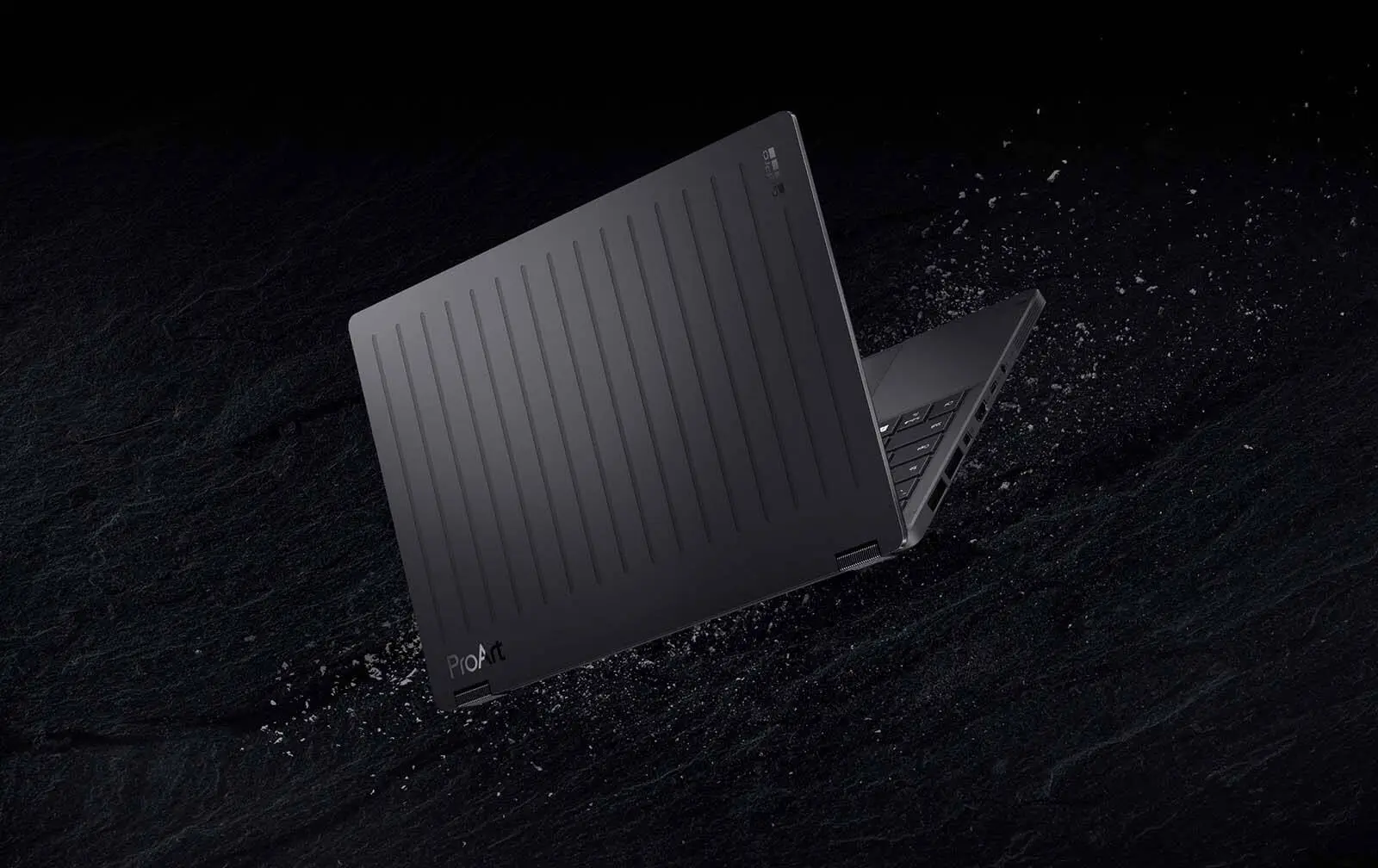Ноутбук ASUS ProArt GoPro Edition (PX13) у відкритому вигляді, на темному фоні.
