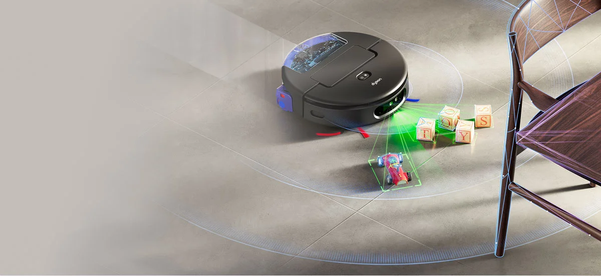 Перед роботом розташовані кубики, іграшкова машинка та стілець. Пристрій виявляє та уникає перешкод на своєму шляху.