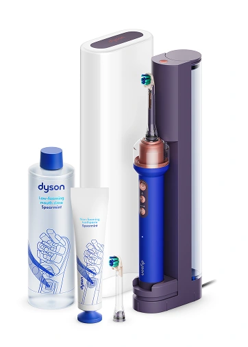 Набір продуктів Dyson: синя щітка в док-станції, футляр, насадка, білий тюбик зубної пасти та пом'якшувач тканини