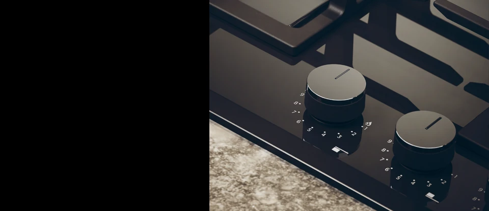 Фрагмент чорної газової варильної поверхні з двома ручками.