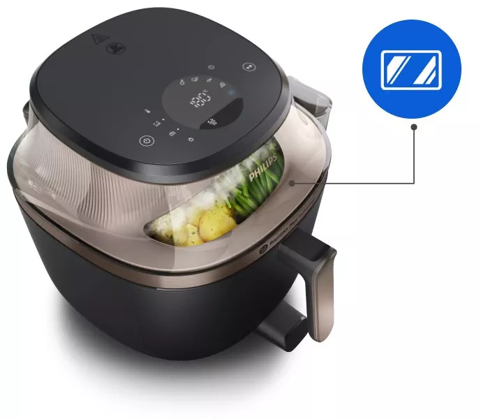 Овочі запікаються в аерофритюрниці Philips NA547/07, що видно через віконце всередині.