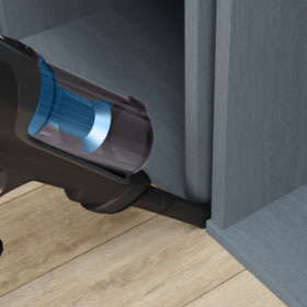 Ручний пилосос Tefal X-Force Flex пилососить простір між меблями.