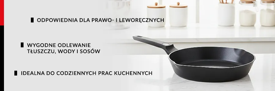 Patelnia ZWIEGER KORRA leżąca na białym blacie kuchennym w jasnej kuchnii, tle pojemniki na przyprawy