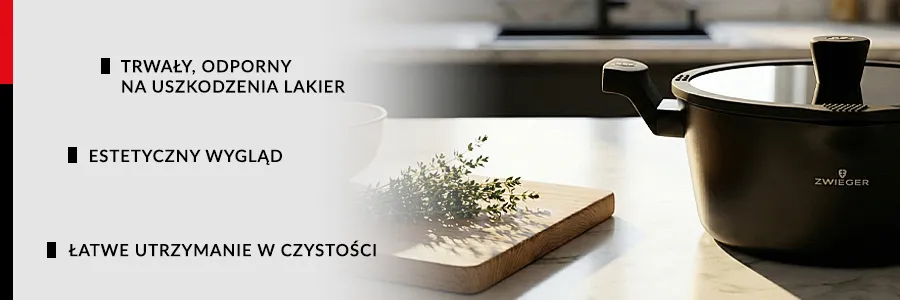 Garnke ZWIEGER KORRA z pokrywką stojący na drewnianym blacie kuchenny na którym leżą również pomidorki koktailowe, przyprawy oraz zielone liście sałaty, w tle widać tradycyjnie wyposażoną kuchnię