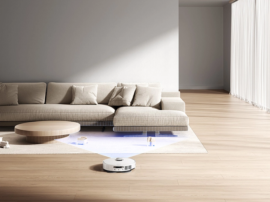 Робот пылесосит пол, обнаруживая препятствия в помещении.