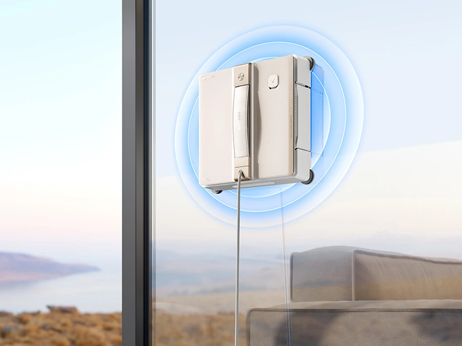 Робот для миття вікон приклеєний до вікна синіми колами, що ілюструють, як працює присоска.