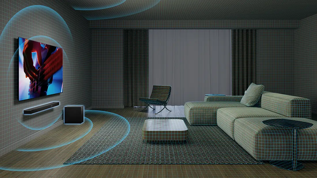 Вітальня з настінним телевізором, саундбаром та сабвуфером. Диван, крісло та журнальний столик стоять на килимі.