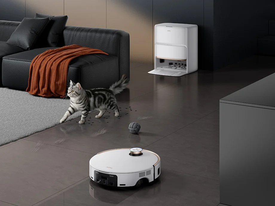 Робот-прибиральник миє брудну підлогу у вітальні, поки повз проходить кіт.