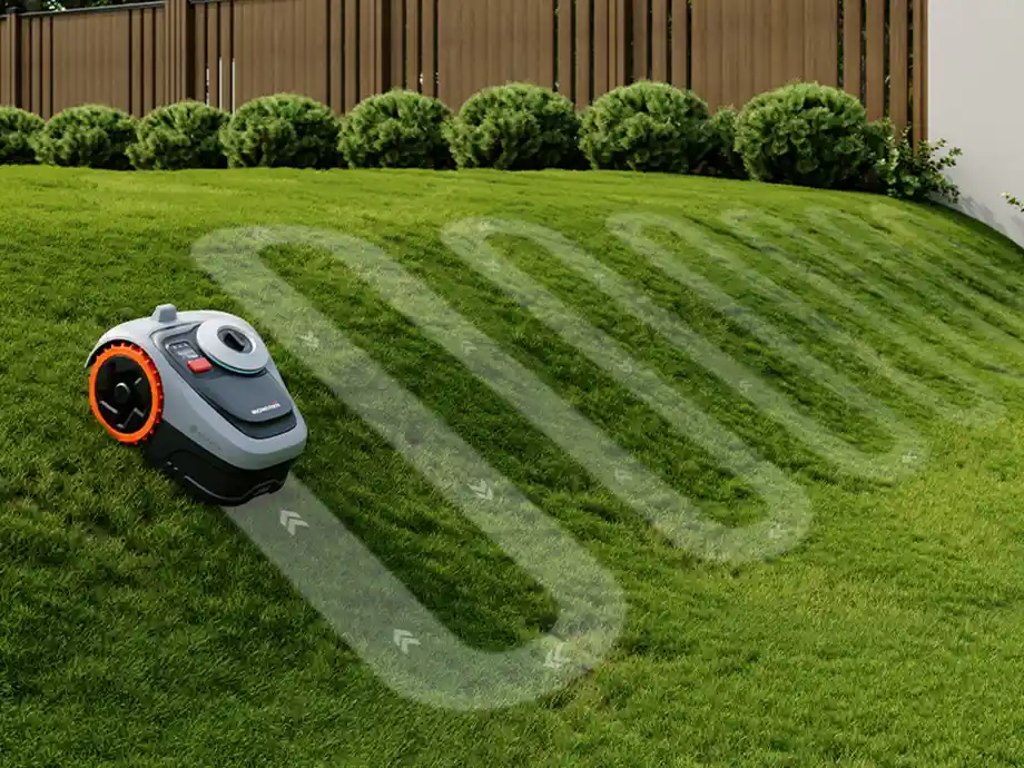 робот косить газон на пагорбі, з позначеним маршрутом скошування на газоні, навколишня територія - сад